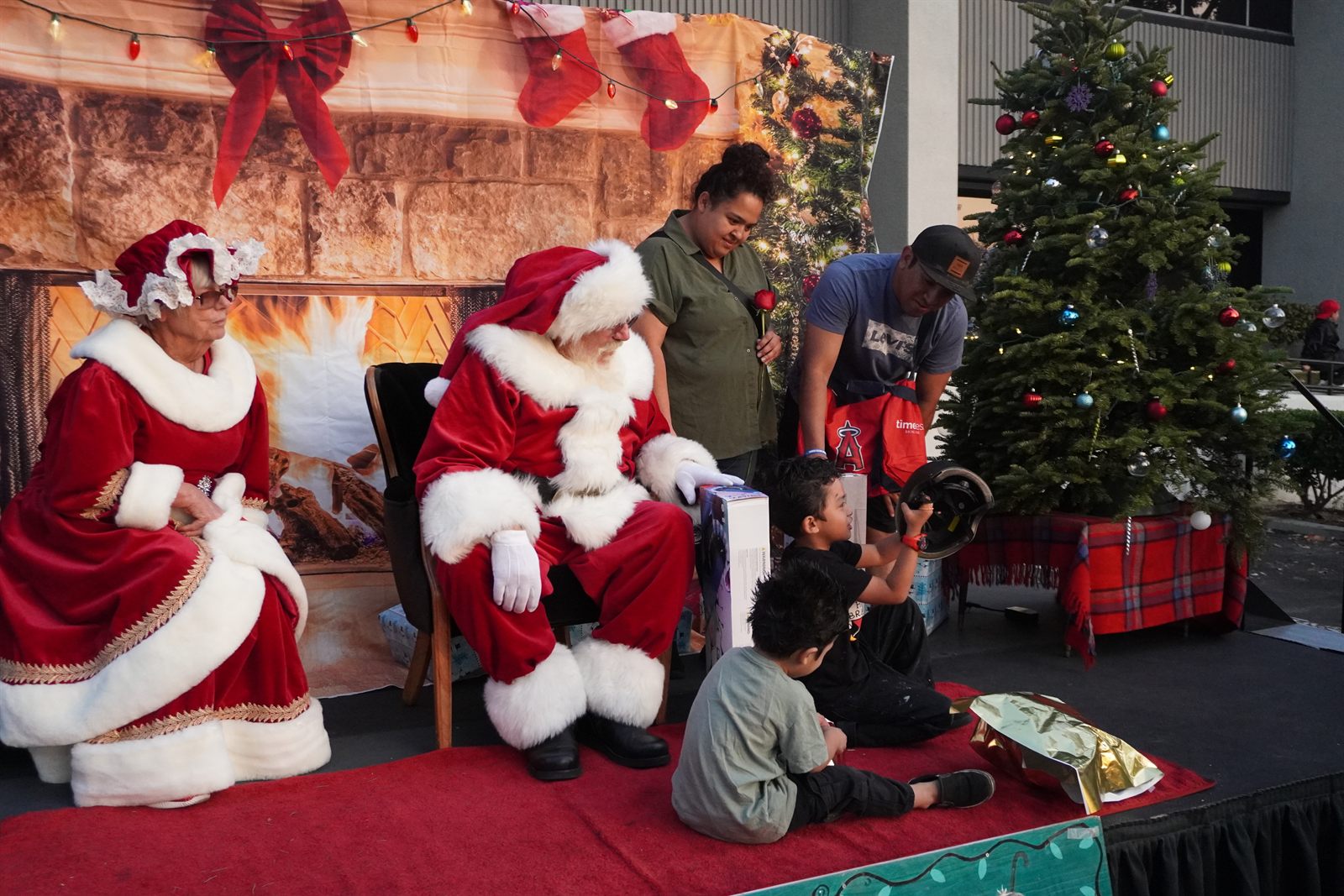 Children receiving gifts from Santa at the C.O.O.P. Foundation Christmas Family Drive