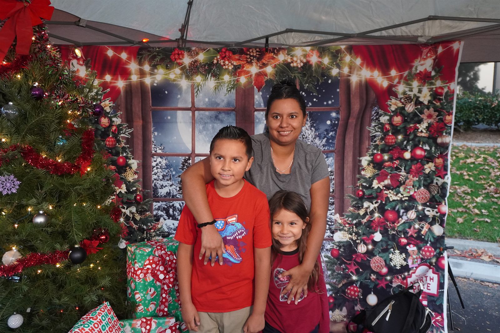 A mother and her two children at the Christmas Family Drive