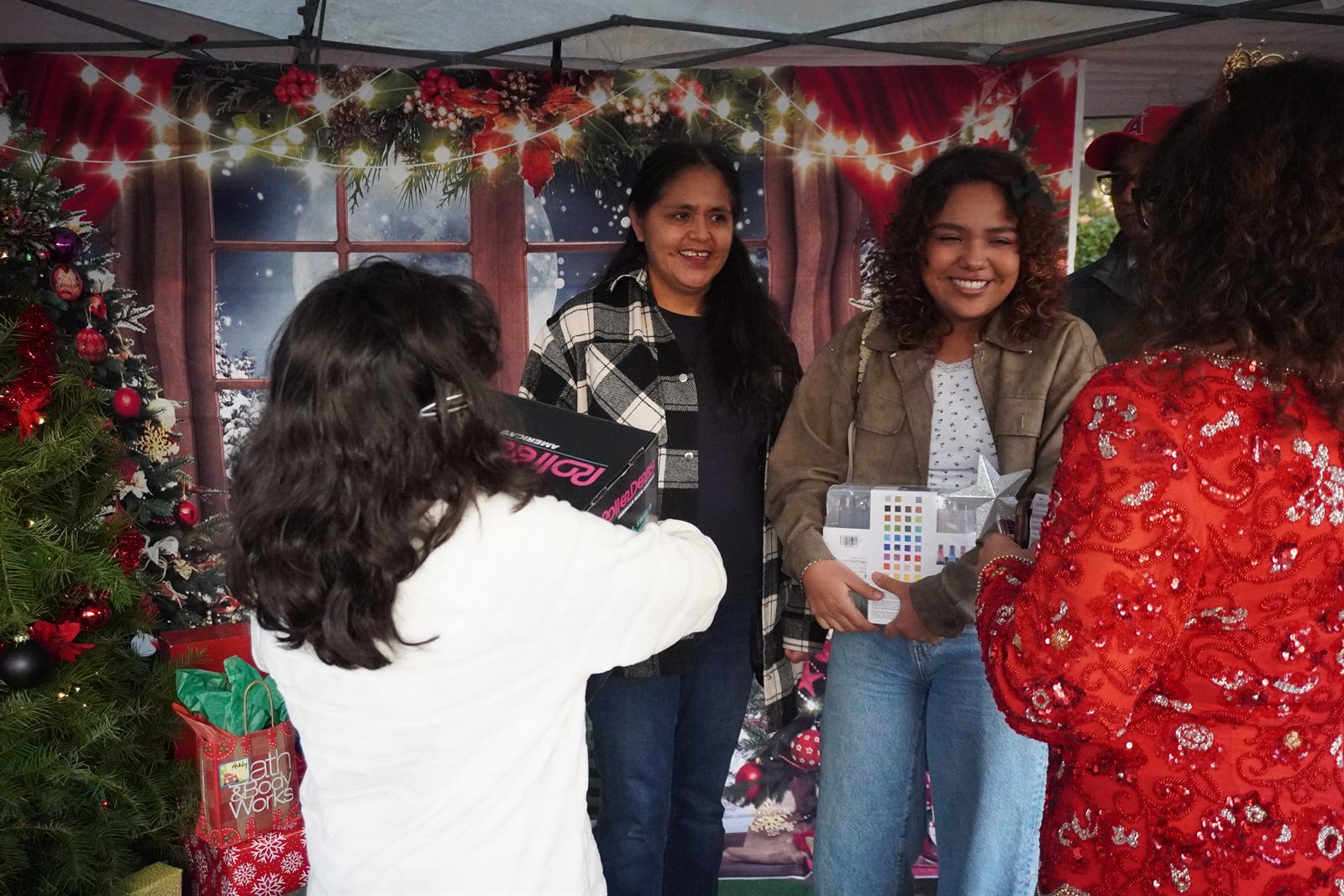 A family lighting up as they receive a gift